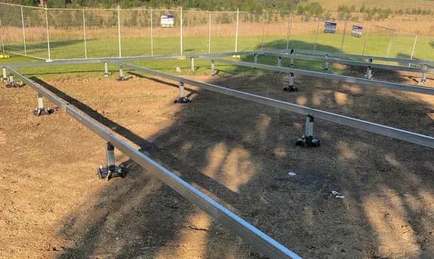 ALLFOOT concrete-free footing system installed in a field showing metal support structures for solar panels